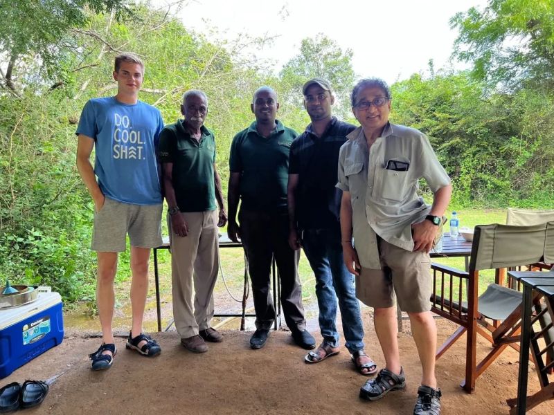 Chinthaka with travelers at a safari lodge